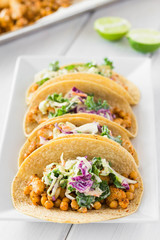 Chickpea Cauliflower Vegan Tacos with Cabbage Slaw Mexican Food on a Crisp White Wooden Background