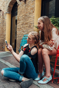 Two teen girls checking a smartphone