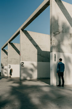 Man and Woman Standing Outside of A Handball Court