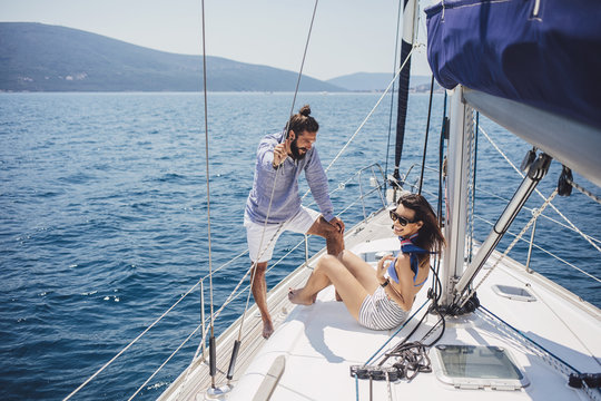 Couple Enjoying Summertime on Sailboat
