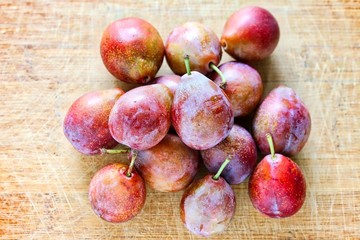 Fresh Sugar Plum On Wooden Cutting Board