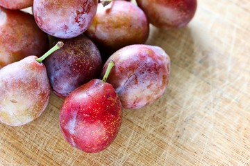 Fresh Sugar Plum On Wooden Cutting Board