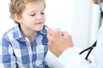 Doctor and child patient. Physician examines little boy by stethoscope. Medicine and children's therapy concept