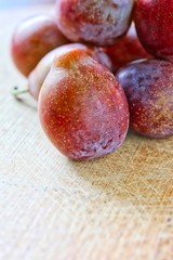 Fresh Sugar Plum On Wooden Cutting Board
