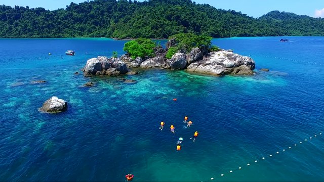 snorkeling crystal clear blue water of the island