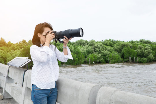 Female bird and wildlife photographer taking pictures