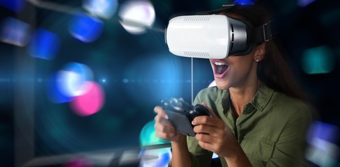 Naklejka premium Composite image of woman playing video game with virtual reality