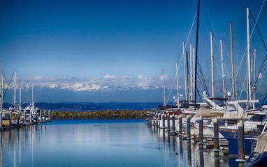 Reflections of sailboats in marina