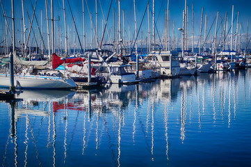 Sailboats in marina with Olympic Mountains