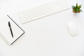 White Workspace with keyboard And notebook