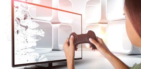 Composite image of woman playing video game against white