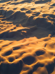 Aerial view of sand dune at golden hour.