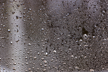 Blue water drops on window glas background