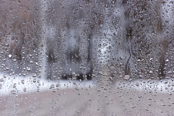 Blue water drops on window glas background