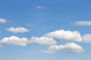 Cumulus clouds against a blue sky.