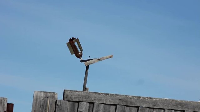 Weather vane flugel blows the wind in the village