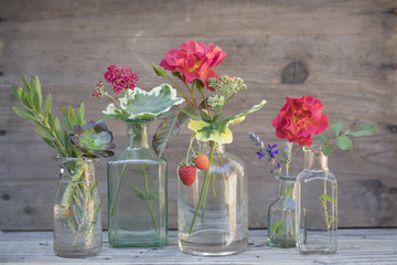Small flower bouquets in glass jars