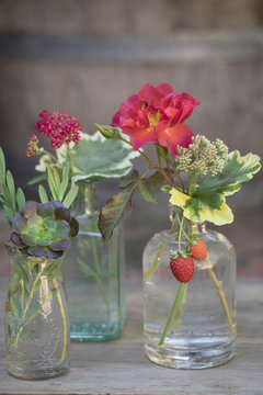 Small flower bouquets in glass jars