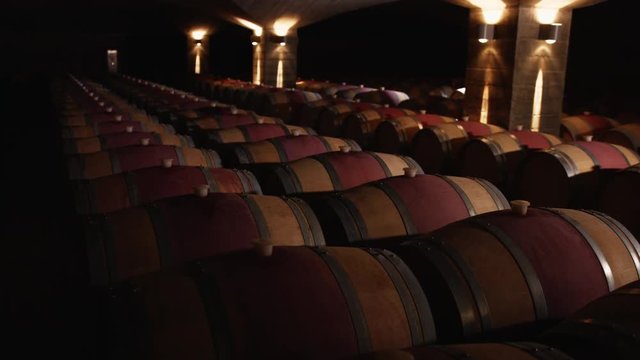 Red Wine Caskets In Dimly Lit Cellar, Hawkes Bay, New Zealand.