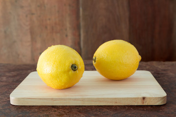 Lemons on a wooden plate