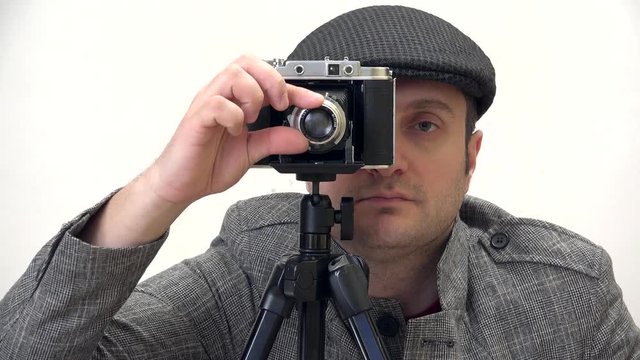 Man portrait looking on photo vintage camerta lens