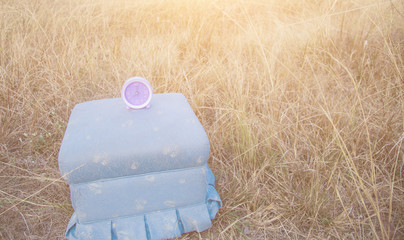 Set your clocks back with this clock in grass against a bright Daylight saving time concept.