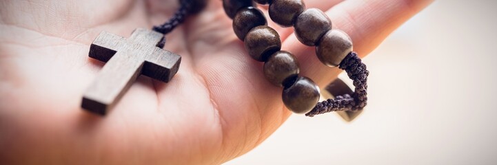 Hand holding rosary beads