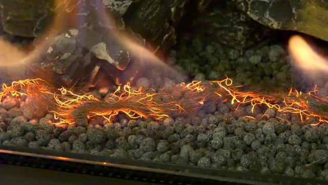 Biofireplace burn on ethanol gas. Contemporary mount biofuel on ethanol fireplot fireplace close-up. Decorated bio fireplace. Modern ecological technologies. Interior design of a house inside.