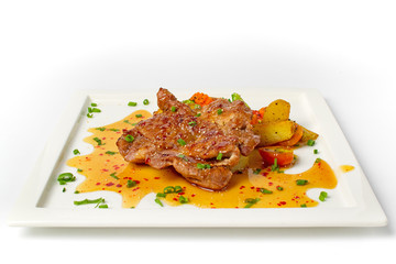 Thai cuisine north eastern style, fusion food grilled pork steak spicy salad serve with mix vegetable and fried potatoes on white background