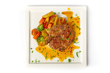 Thai cuisine north eastern style, fusion food grilled pork steak spicy salad serve with mix vegetable and fried potatoes on white background