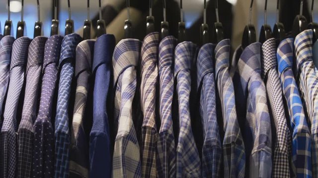 Pan across a rack of dress shirts