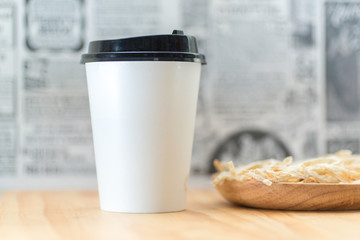 Take away coffee on wooden background