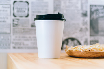 Take away coffee on wooden background
