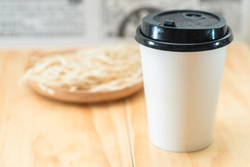 Take away coffee on wooden background