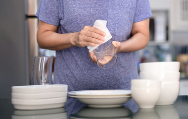 Woman Cleaning product concept wiping dishware cleaner in home and kitchen