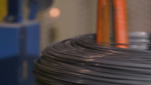 Metal spring coils being wound in a factory