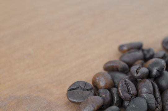 Roasted coffee beans on wooden table
