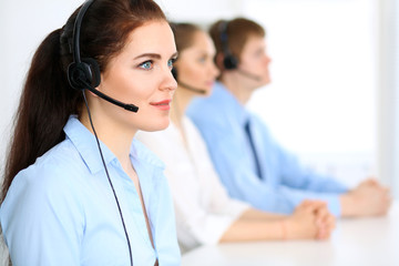Call center operators. Focus at  business woman in headset