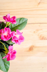 Beautiful artificial flowers on wooden background