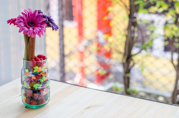 Beautiful artificial flowers on wooden and nature background