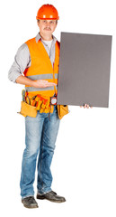 male builder or manual worker in helmet with white blank banner over white wall background.