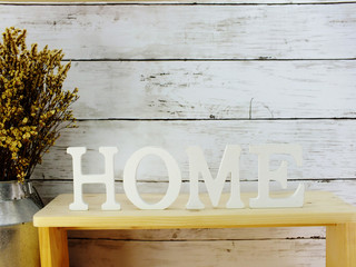 decorative letters word home with dried flowers on wooden background