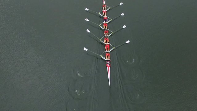 Overhead aerial of rowing team in boat rowing together