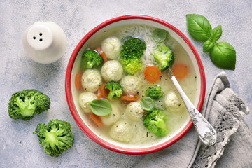 Soup with chicken meatballs, rice, broccoli and green pea.Top view.