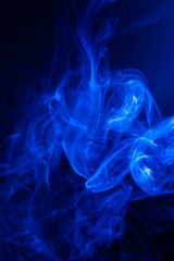 Obraz premium Blue smoke on black background.