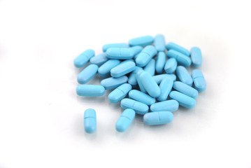 Oval blue tablets closeup on white background