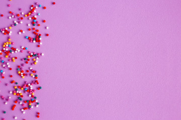 Texture background of pink color with sweet confetti