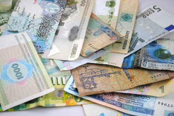 Old and new banknotes of different countries on white background