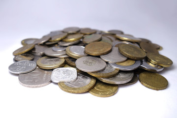 Old and new coins of different countries closeup on white background