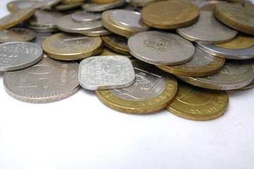 Old and new coins of different countries closeup on white background